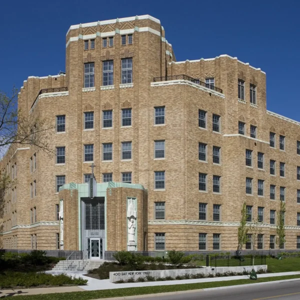 A large, multi-story Art Deco style brick building with geometric designs, tall windows, and a prominent entrance at 400 East New York Street.