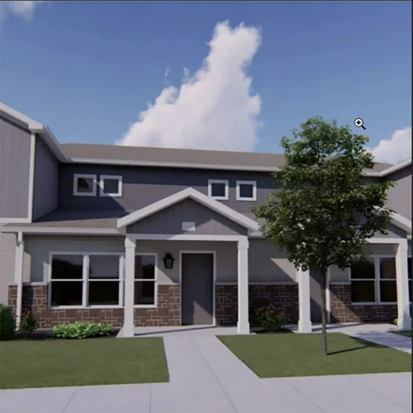 A two-story townhouse with a covered entrance, stone and siding exterior, lawn, sidewalk, and a tree in front.