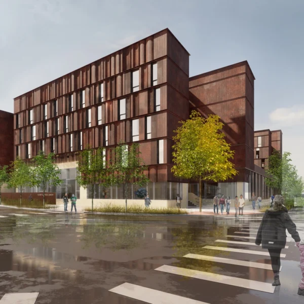 A modern, multi-story building with a rust-colored facade and large windows, surrounded by trees and pedestrians on a wet city street.