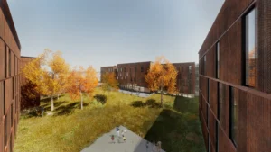 A grassy courtyard with autumn trees is surrounded by modern, rust-colored buildings under a clear sky. People are gathered in the foreground.