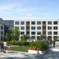 A modern three-story apartment building with large windows, people walking on the sidewalk, greenery, and parked cars in front.