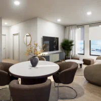 Modern living and dining area with round table, four chairs, a TV on the wall, potted plant, large windows, and neutral-toned furnishings.