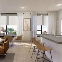Modern kitchen and dining area with barstools, a sofa, dining table, large windows with sheer curtains, and neutral decor. Natural light fills the space.