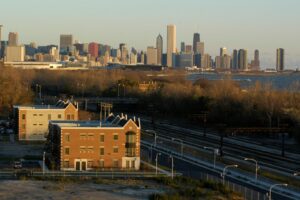 The Chicago skyline viewed from across train tracks and an urban landscape.